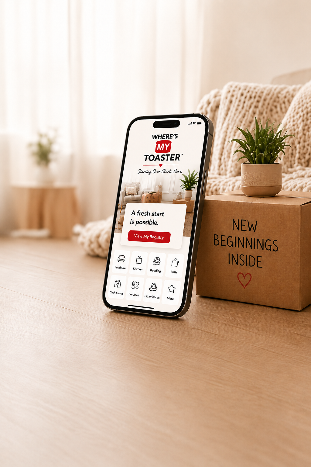 Where's My Toaster app on a phone beside a moving box